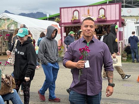 A person standing holding flowers in hand