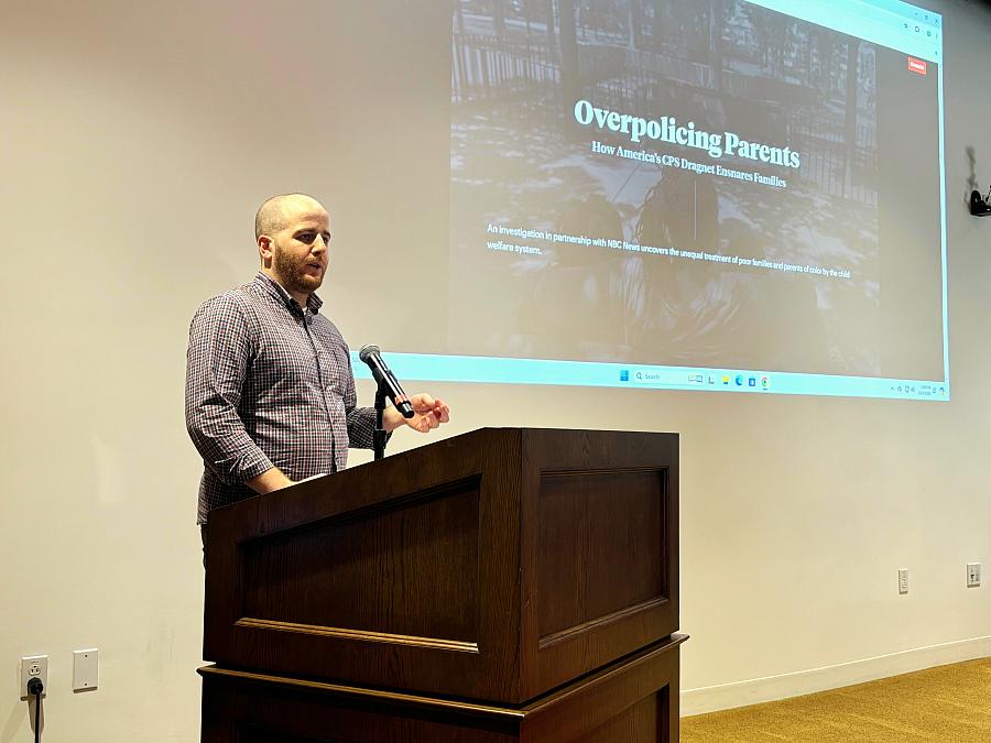 Eli Hager speaks at a podium.