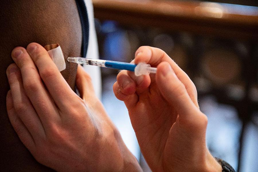 Healthcare worker vaccinating a person