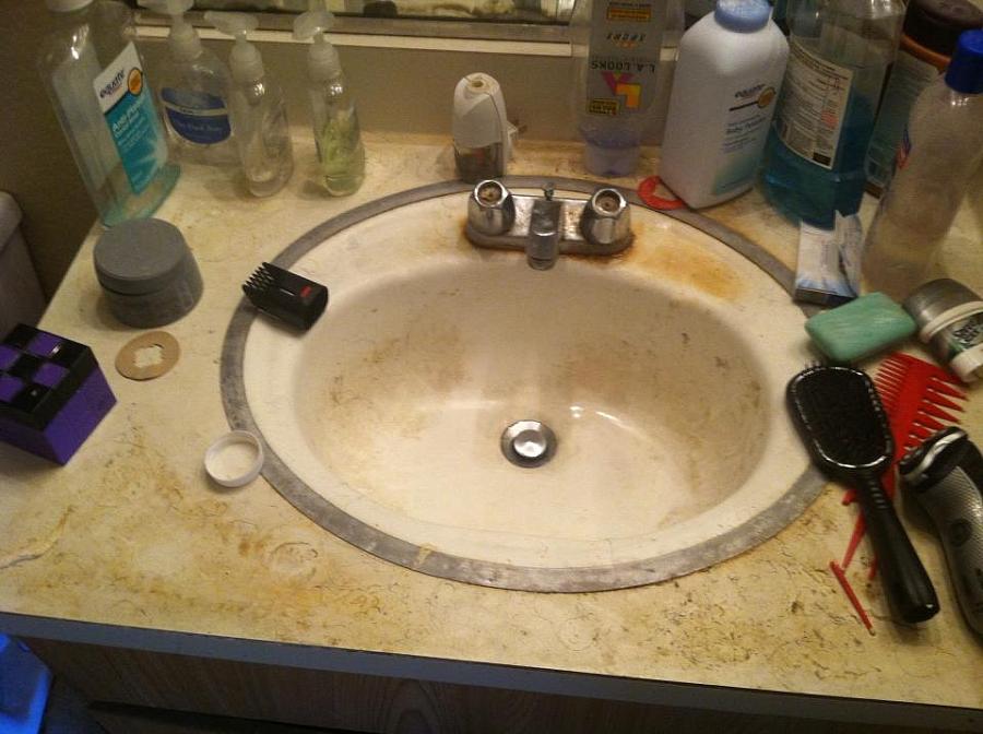 a sink surrounded by bathroom products