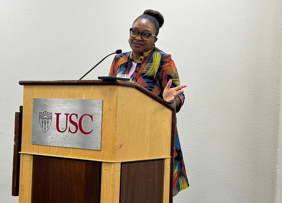 Journalist Akilah Johnson talks at a podium.