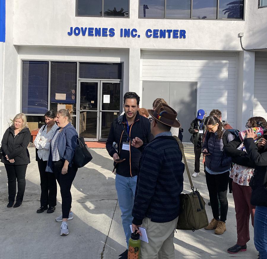Reporters stand outside Jovenes in Boyle Heights during a field visit. 