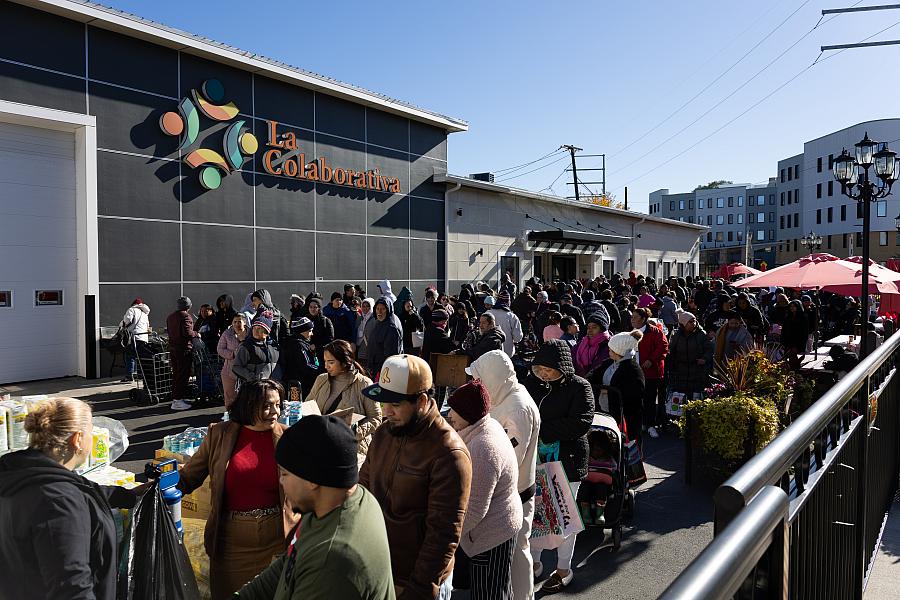 People waiting in line to pick up food 