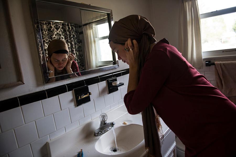 Person standing in front of a bathroom mirror