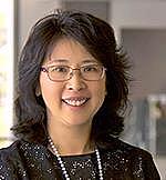 A headshot of Lihua Lu, with dark hair and glasses, who is the Director and Principle Investigator of the Surveillance Epidemiology End Results (SEER) Program
