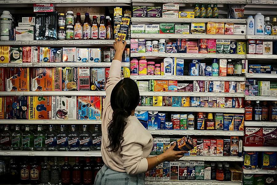 A person in a store reaching for an item