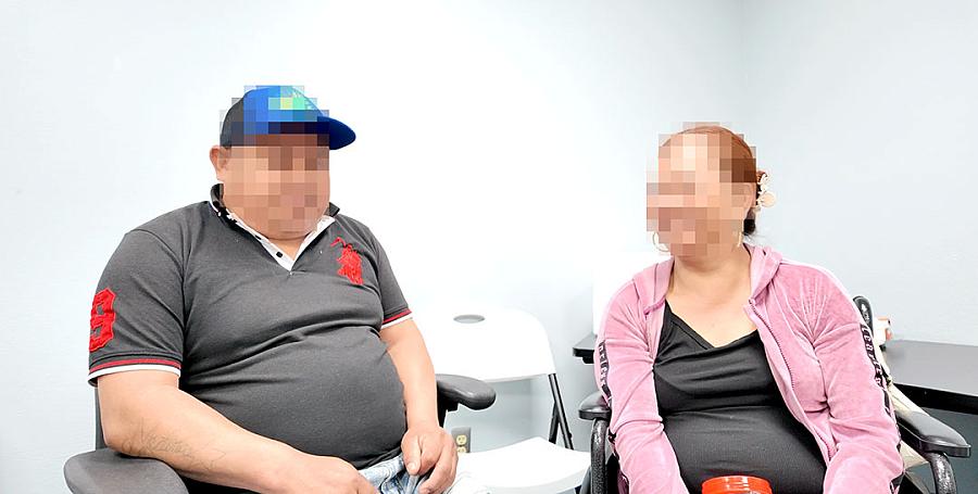 A couple with blurred out faces to protect their identities share a laugh at the clinic.
