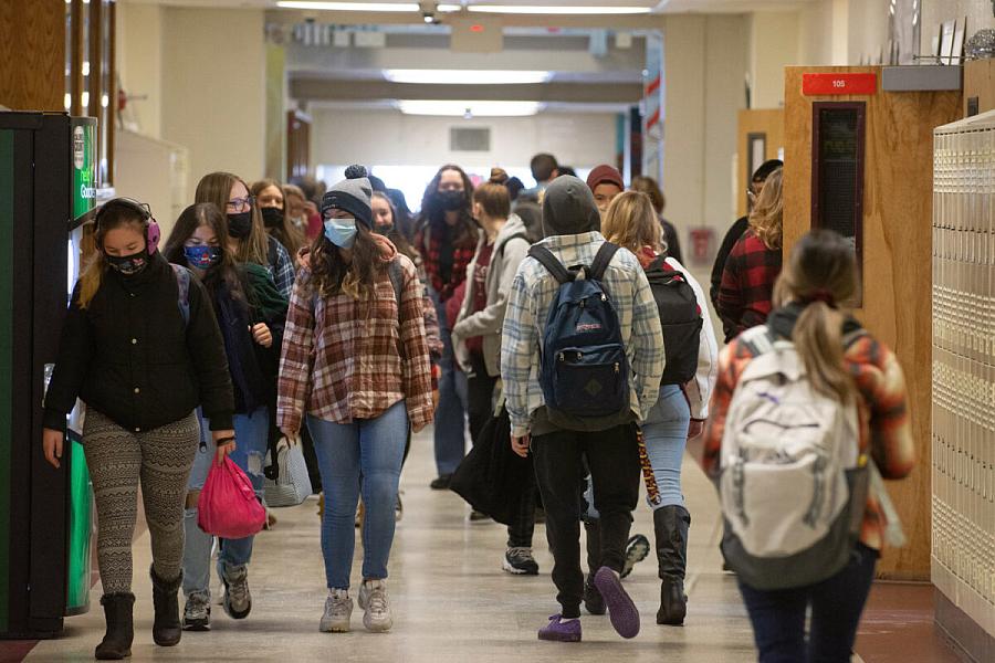 People walking through a hallway