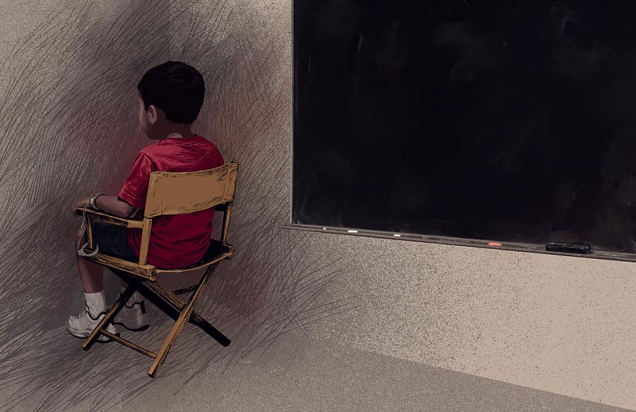 A boy sitting in the corner 