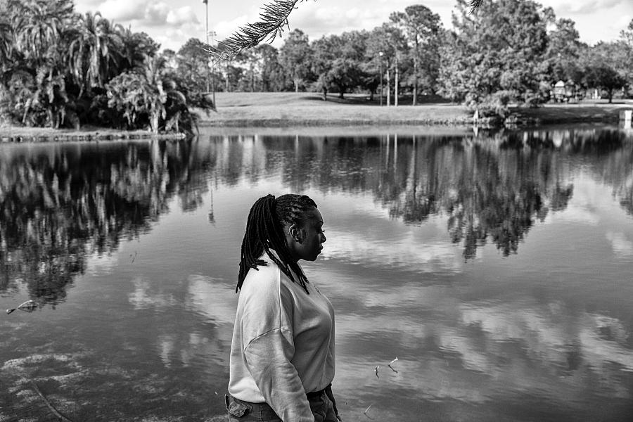 Black and white picture of a person by a lake