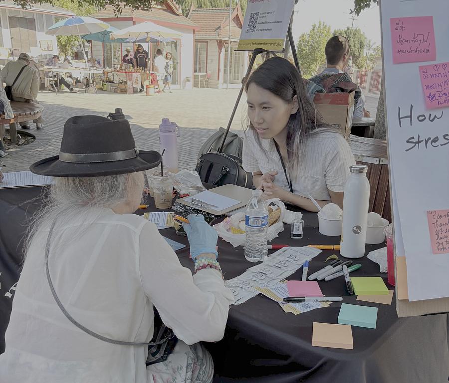 Two people taking at a community event