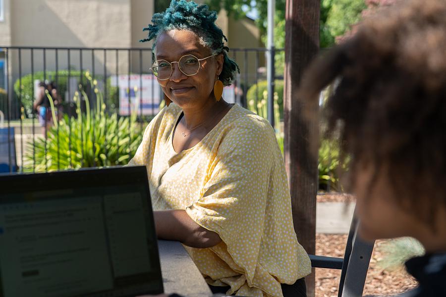a woman on her laptop outside