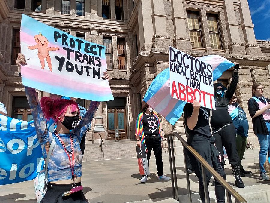 Image of protesters marching for trans youth.