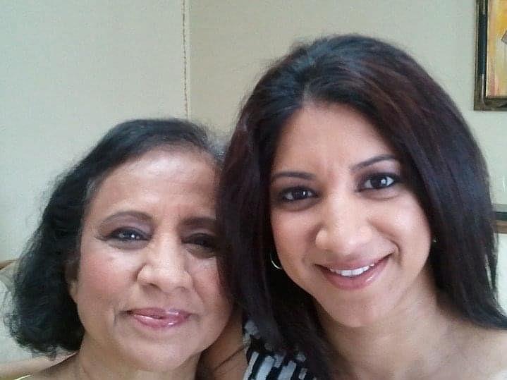 Two Indian women smile at the camera