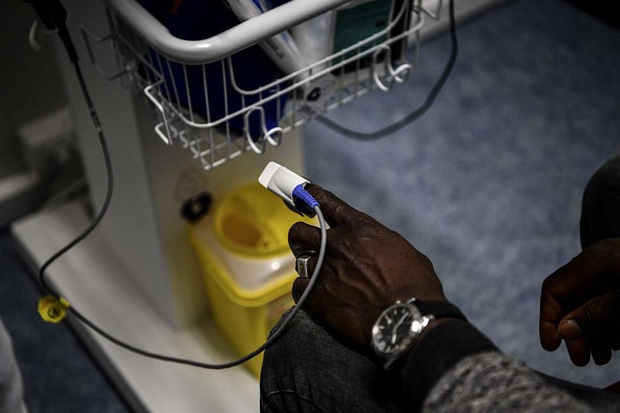 A patient using a pulseoximeter in the hospital