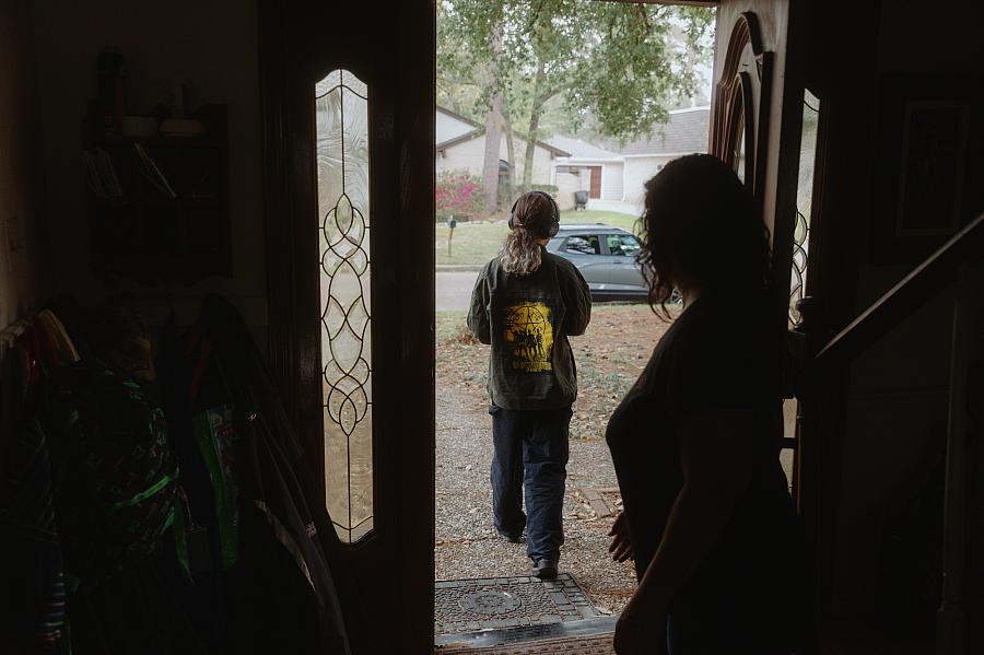 A girl walking out of a door 