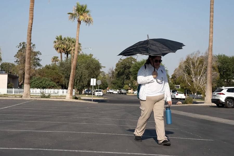 Person walking with an umbrella in their hand 