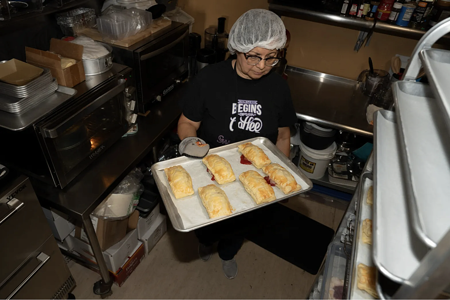 Person with a tray full of pastry