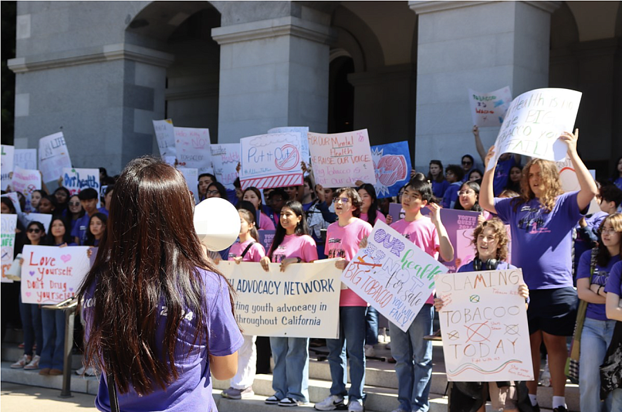 People gethered together holding signs