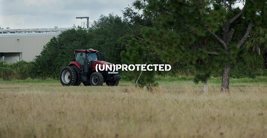 Text with field and vehicle in the background