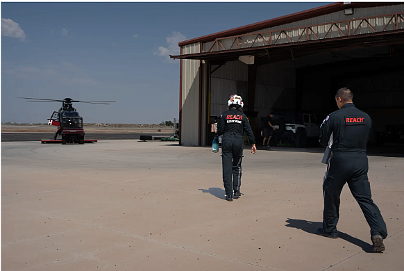 People walking towards a helicopter