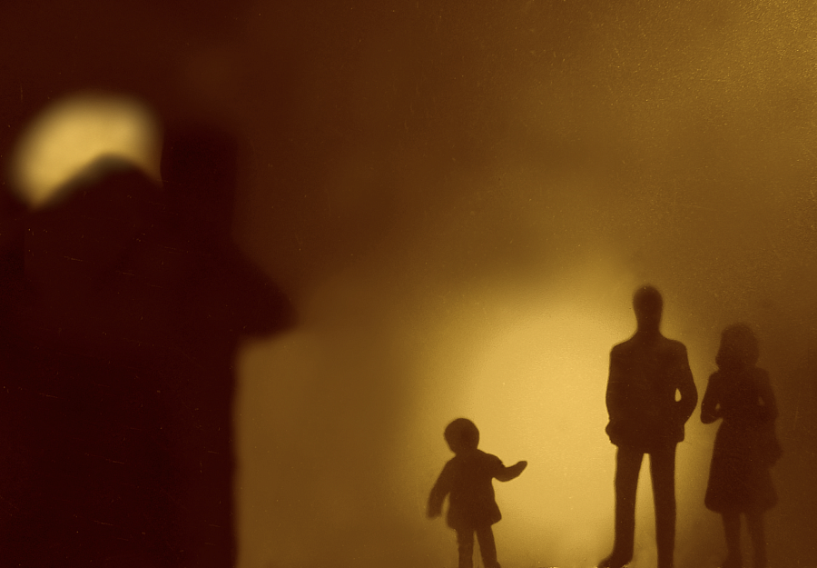 Silhouette of a child and 2 people