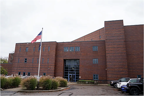 Building with a flag in front of it