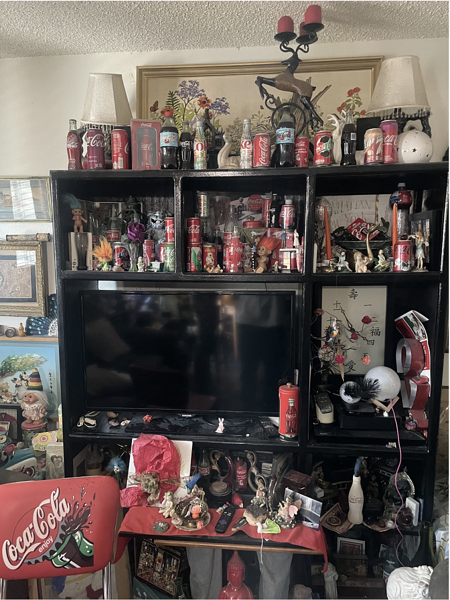 Shelf filled with Coca-Cola memorabilia and other little trinkets