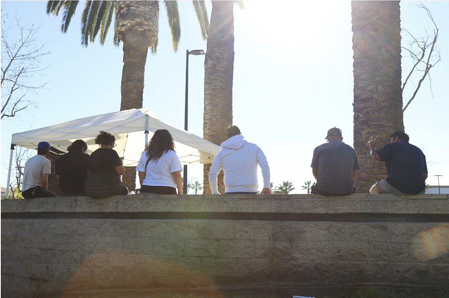 The Lucha Santa Ana hub sits alongside a wall with jornaleros as the day begins to unwind.