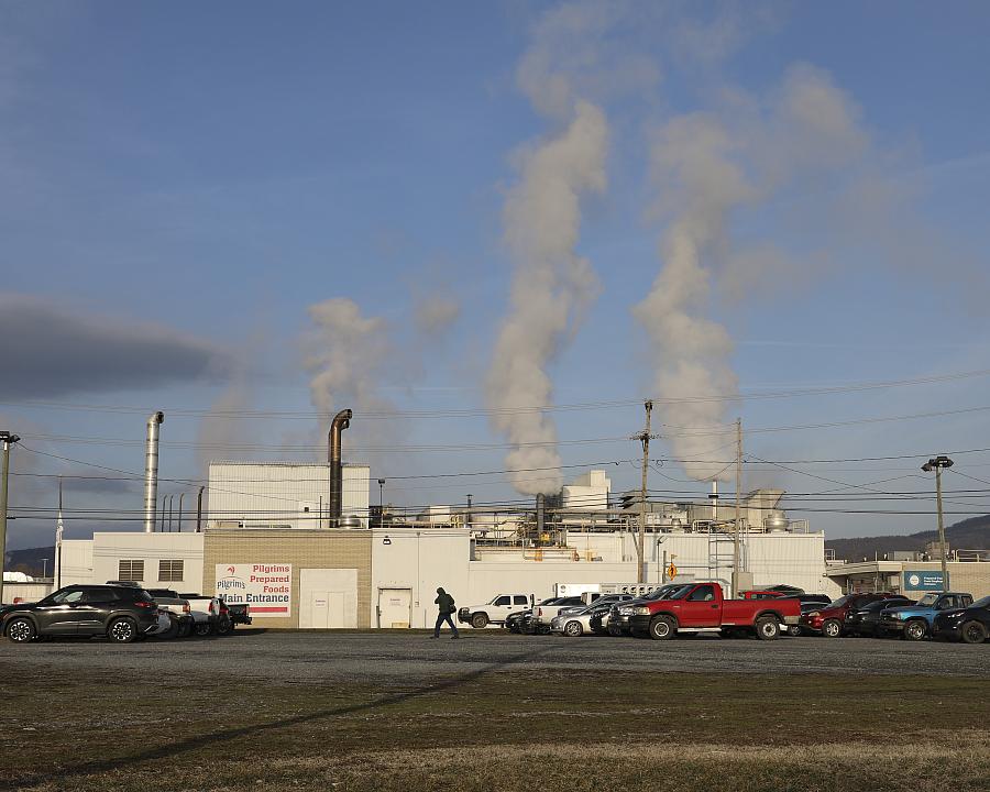 Smoke coming out of multiple chimneys of a building