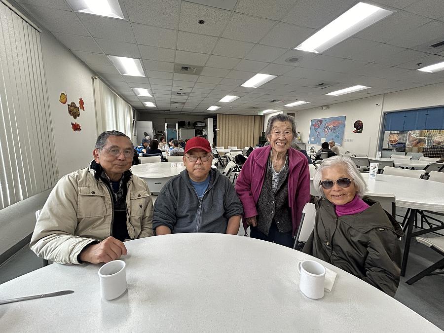 4 people in front of a white table