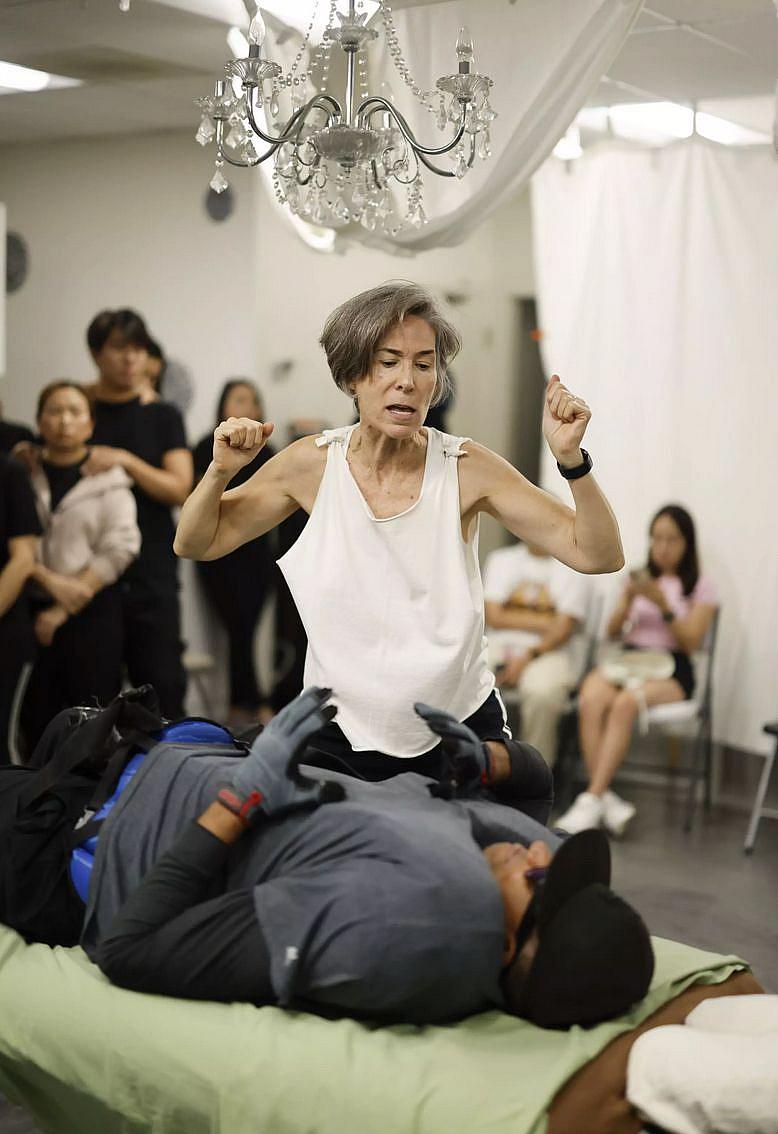 Person standing on table to do a demonstration