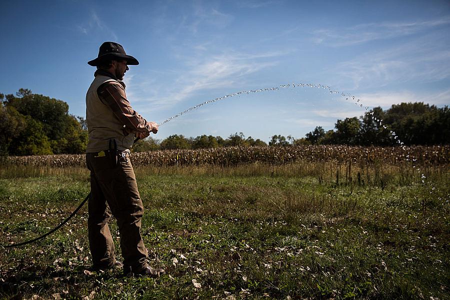 Man watering his farm.