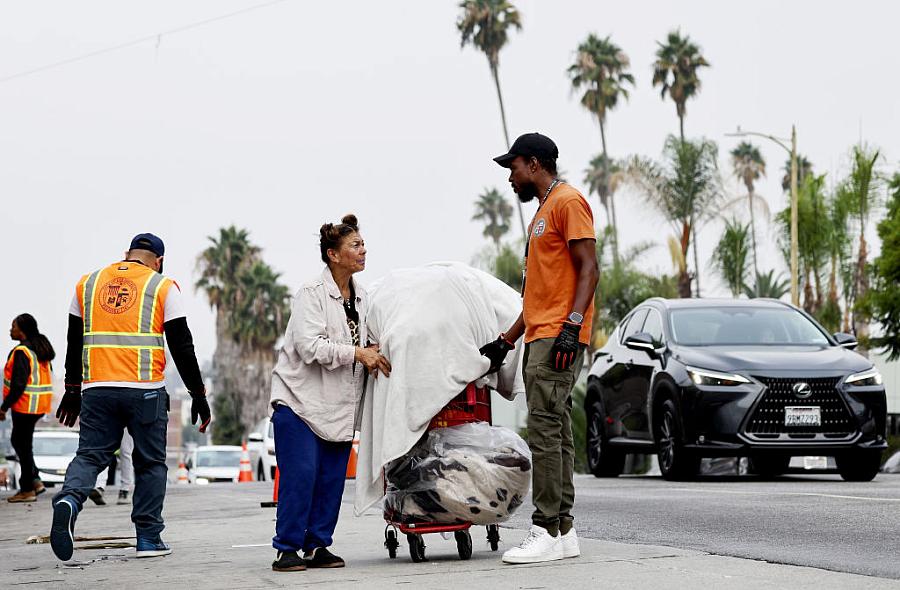 A city worker speaks to an unhoused person