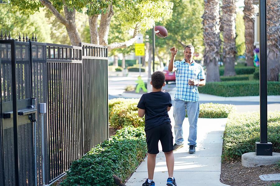 A person playing catch with a child