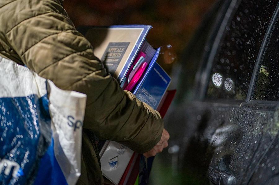 Image of person carrying files