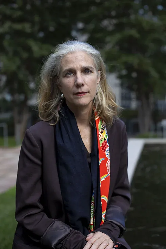 Person with whitish hair and coat 