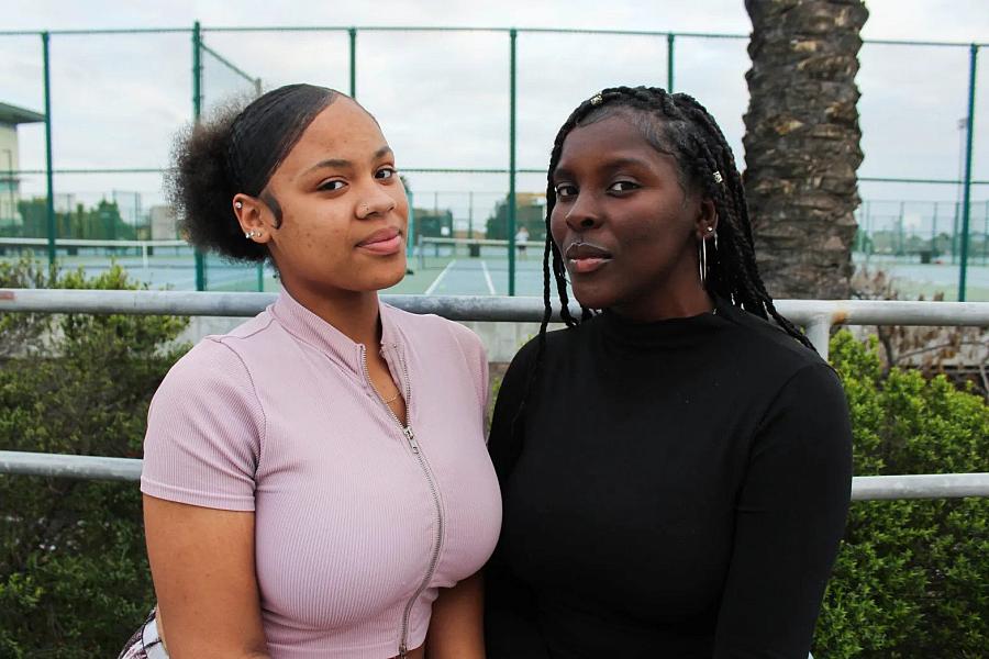 Chrishana Bunting, 16, left, and Lizette Pierce, 16, pose for a photo inside the Lincoln High School library in San Diego on Feb. 13, 2023. (Anissa Durham/Word In Black)