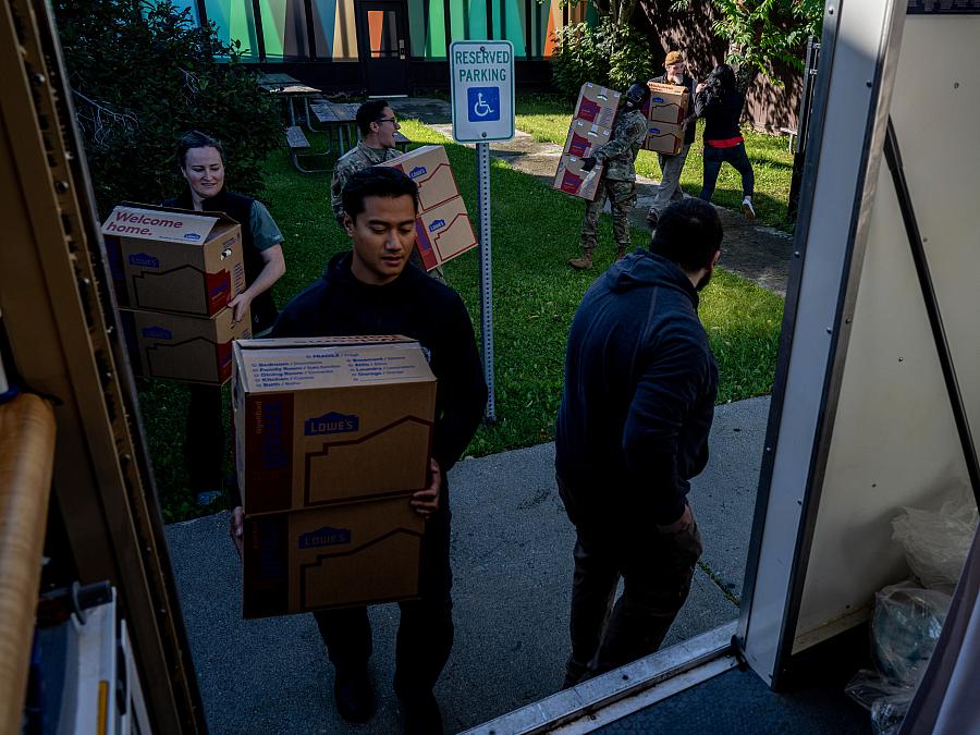 People loading kit boxes