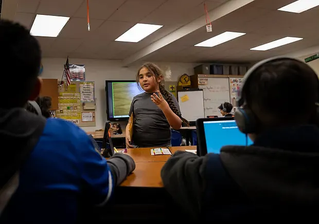 Girl speaking in front of classroom