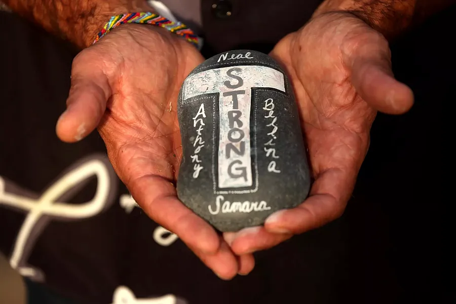 A persons hands holding a rock