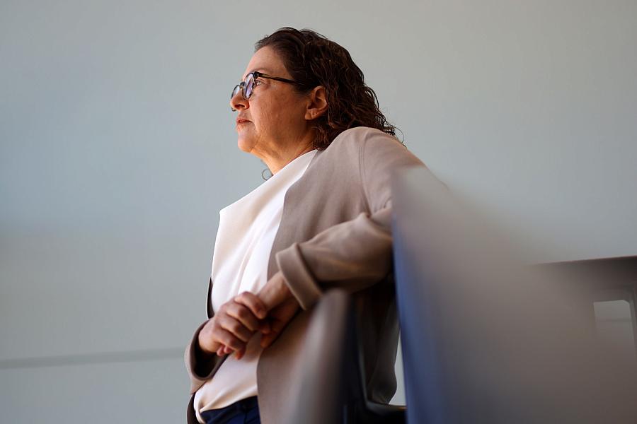 A person standing against a chair