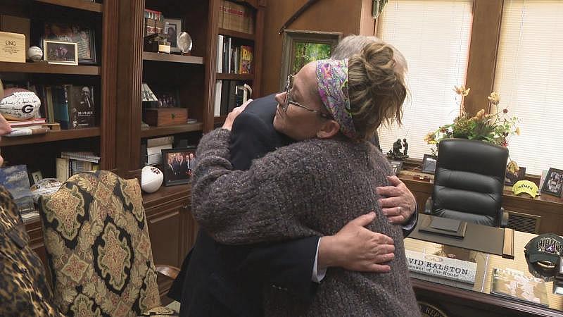 Christina Henry, a mother whose daughter's ordeal was prominently featured in Rebecca Lindstrom's "Keeping" series, embraces Georgia House Speaker David Ralston after the passage of the state's mental health reform bill in March 2022.