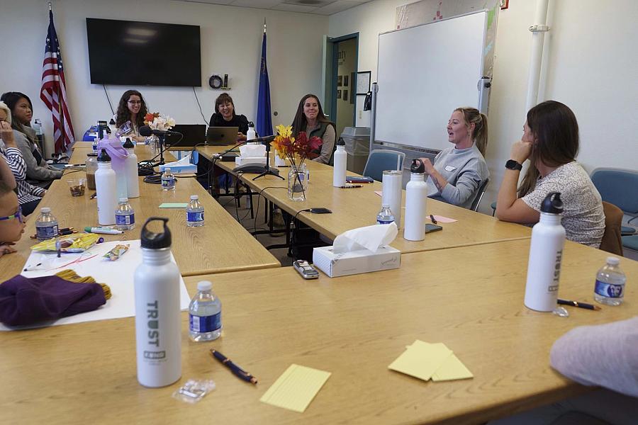 Image of people sitting across table