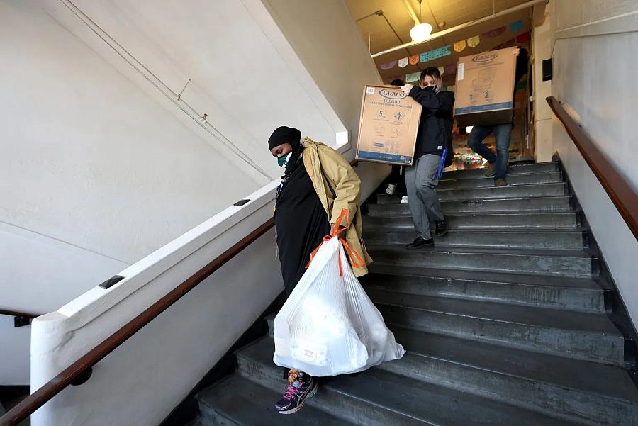 Aisha Abdi carrying supplies for her clients with Stephanie Quinn and Stacey Silver