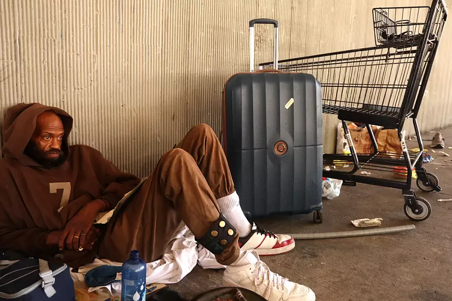  A man sits with his belongings