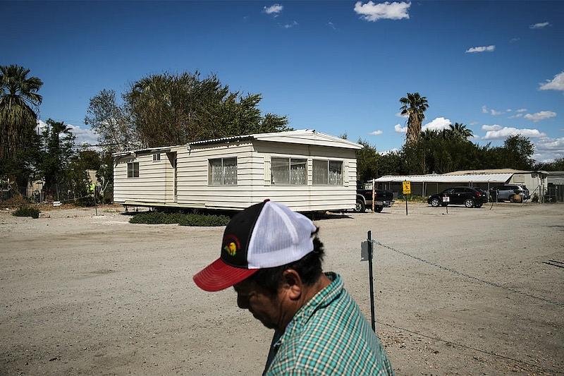 A man with the house in a background