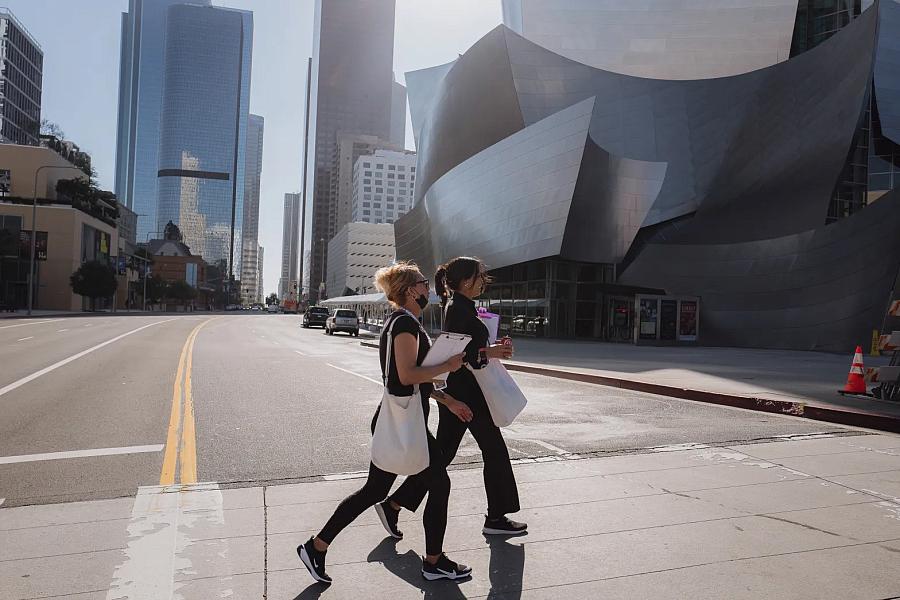 Image of 2 people crossing the street