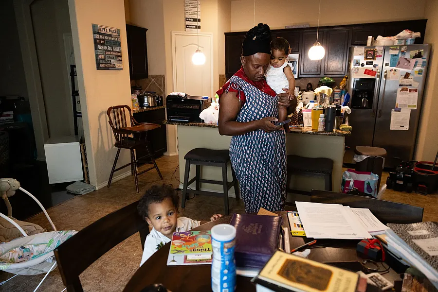 A person with a small child in a home 