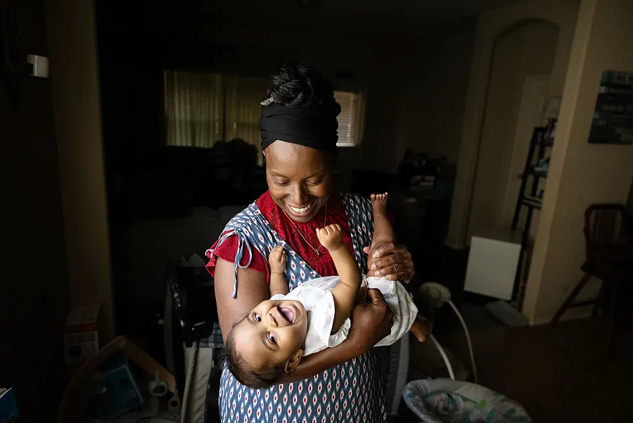 A person pplaying with a baby